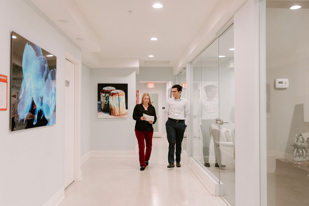 expert in addiction treatment walking down the halls of recovery facility with patient