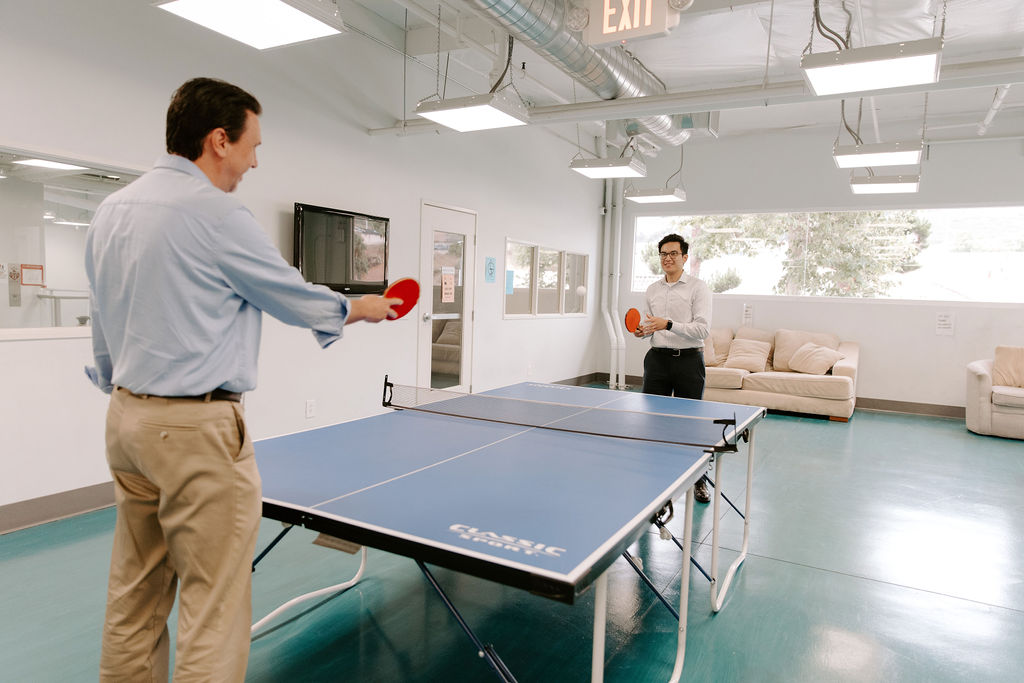 two professionals playing ping pong in addiction recovery